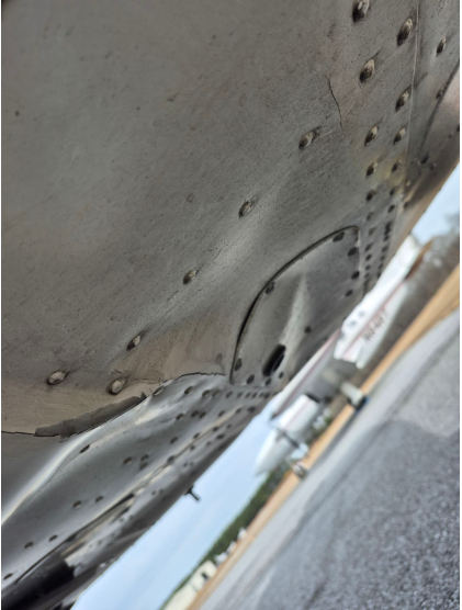 Photograph 2 – View of the Bottom Fuselage Showing Structural Buckling Damage near Fuselage Station 17, from the NTSB investigation of Cessna 172 accident near Atlanta, Georgia, January 28, 2026