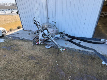Photograph 1 – View of Helicopter and Impacted Hangar, from the NTSB investigation of Hughes 269A accident near Gettysburg, Pennsylvania, February 21, 2026