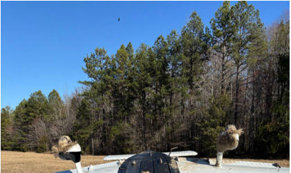 Photograph 1 – Airplane postaccident with fuselage damage at the step and across to the other side of the belly., from the NTSB investigation of Piper PA-28-180 accident near Monroe, North Carolina, February 23, 2026