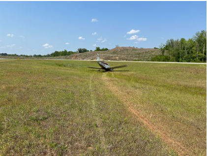 Photograph 1 – Landing gear tracks in the ground leading up to airplane accident location., from the NTSB investigation of Piper PA-28-160 accident near Lanett, Alabama, April 22, 2026