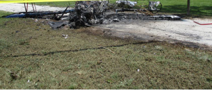 Photograph 1 – Scene, Front View, Showing Tree with Impact Damage, from the NTSB investigation of Waco Classic Aircraft CORP 2T-1A-2 accident near Clermont, Florida, August 14, 2026