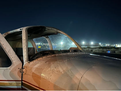 Photograph 1 – Front view of accident airplane with missing windshield, from the NTSB investigation of Beech 95 accident near Yuma, Arizona, November 18, 2023