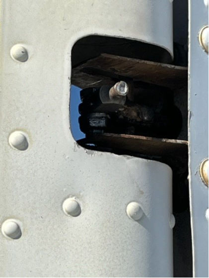 Photograph 3 – View of broken rudder trim tab rod end, from the NTSB investigation of Beech 95 accident near Yuma, Arizona, November 18, 2023