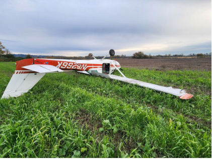 Photograph 1 – View of nosed over airplane with damage to aft fuselage, from the NTSB investigation of Cessna 150M accident near Woodland, Washington, November 18, 2023