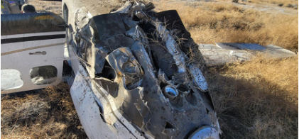 Photograph 5 - Accident site, lower cowling., from the NTSB investigation of Cessna P210N accident near Big Bear, California, December 2, 2023