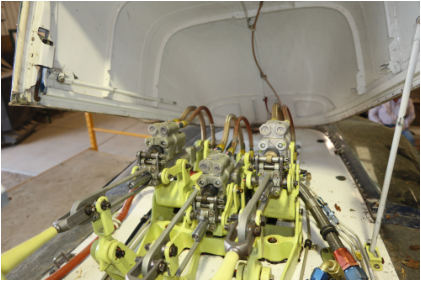 Photo 4 – Servo actuators in upper deck during postaccident wreckage layout, from the NTSB investigation of Bell 206L-3 accident near Tracy, California, April 23, 2024