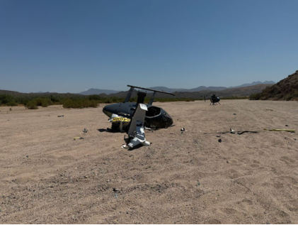 Photograph 3 – Top view of the helicopter at the site, from the NTSB investigation of Mcdonnell Douglas Helicopter 369 accident near Mesa, Arizona, July 9, 2024