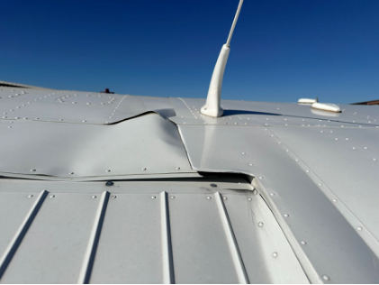 Photograph 5 – Airplane’s left wing as viewed from the top rear side., from the NTSB investigation of Cessna 172S accident near Chandler, Arizona, May 11, 2024