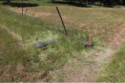 Photograph 3 – View of downed airport perimeter fence post., from the NTSB investigation of Champion 7ECA accident near Cottonwood, California, April 29, 2025