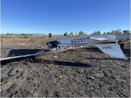 Photograph 3 – View of inverted airplane with damage to vertical stabilizer and rudder, from the NTSB investigation of Cessna 172I accident near Los Angeles, California, November 14, 2024