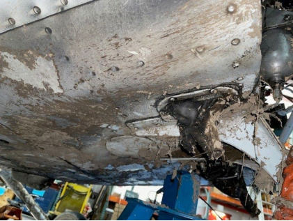 Photograph 4 – View of substantial damage to lower forward fuselage., from the NTSB investigation of Cessna 172M accident near Gig Harbor, Washington, December 13, 2024