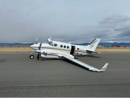 Photograph 1 – The airplane on the runway prior to recovery., from the NTSB investigation of Beech C90A accident near Helena, Montana, March 16, 2025