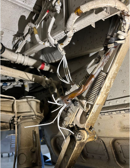 Photograph 3 – The broken wires in the left main landing gear down lock switch wire bundle., from the NTSB investigation of Beech C90A accident near Helena, Montana, March 16, 2025