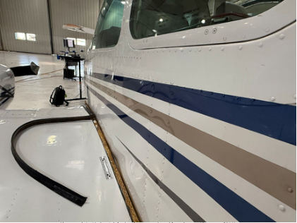 Photograph 1 – Airplane’s left wing damage as viewed from the rear., from the NTSB investigation of Beech 95-B55 (T42A) accident near North Las Vegas, Nevada, July 15, 2025