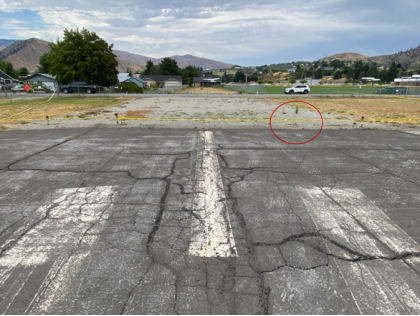 Photograph 3 – Damaged runway end light circled., from the NTSB investigation of Cessna 182Q accident near Cashmere, Washington, July 31, 2025