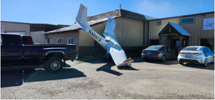 Photograph 1 – Airplane on the side of the building as viewed from the right side., from the NTSB investigation of Cessna 150F accident near Rigby, Idaho, September 17, 2025