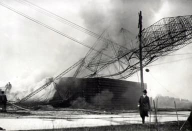 The wreckage of the Roma burns after it crashed into power lines