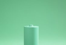 Green battery on green background